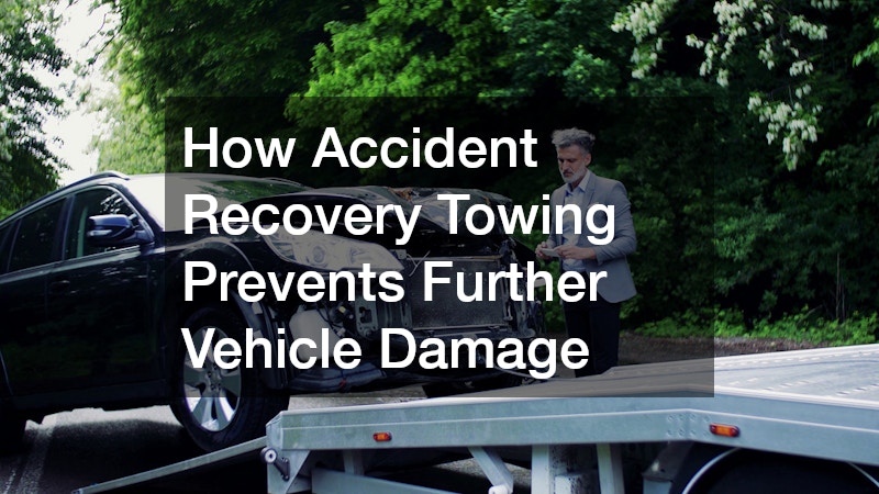 car with front-end damage being loaded onto a flatbed tow truck